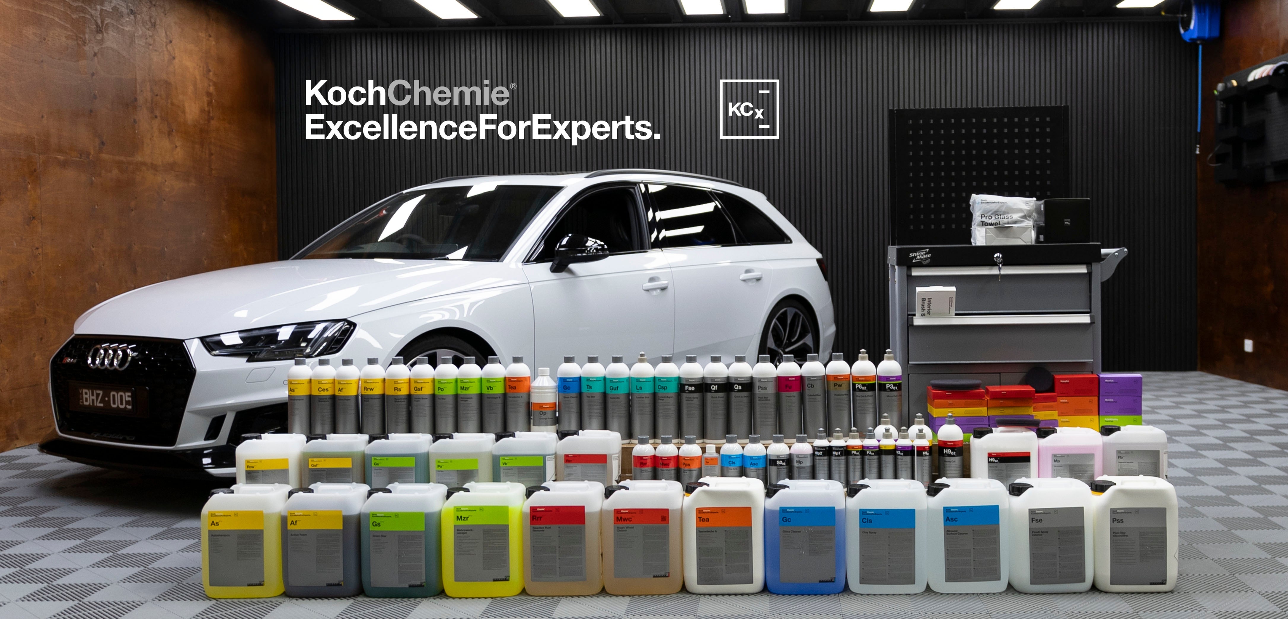 The entire Koch Chemie Range set up in a detailing bay with a white Audi RS4 in the background