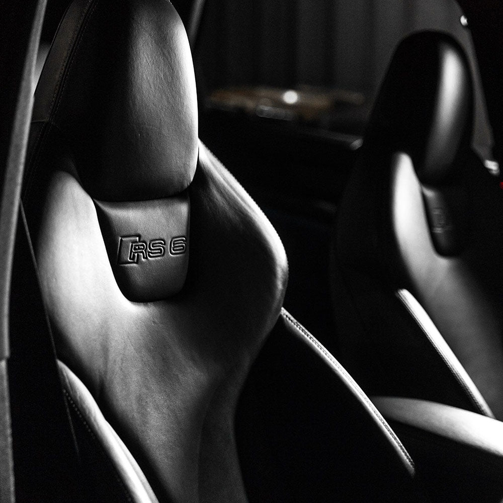 Black leather seats with the Audi RS6 logo. 