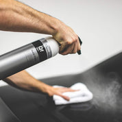 Koch Chemie Quick Finish | Allround, Silicone-Oil-Free Finish Spray 1L bottle being sprays onto a black car.