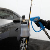 MTM Foam Cannon attached to an MTM Short Gun applying a thick foam to a black car.